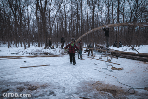 A Man In A Plaid Shirt Walks In The Snow GIF
