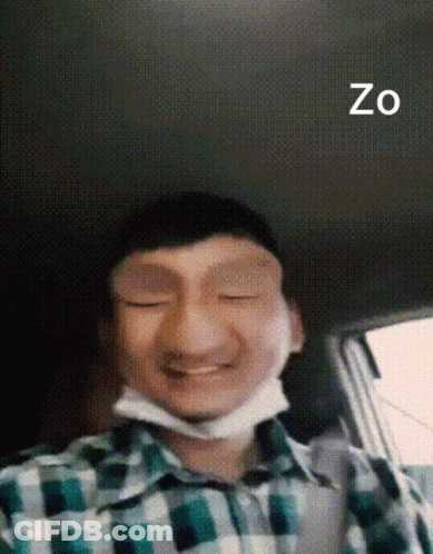 A Man In A Plaid Shirt With A Mask On His Face And The Word Zo On The Bottom Right GIF