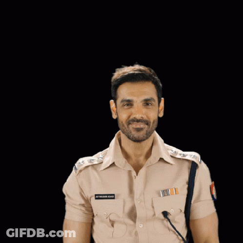 A Man In A Police Uniform Flexes His Muscles And Has A Name Tag On His Chest That Says S.p. Singh GIF