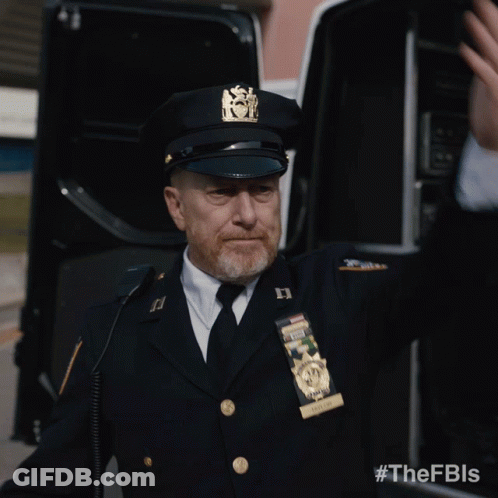 A Man In A Police Uniform Has A Badge That Says New York State Police GIF