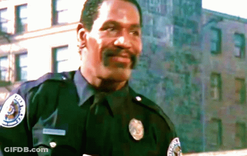 A Man In A Police Uniform Has A Patch On His Chest That Says ' Metropolitan Police ' GIF