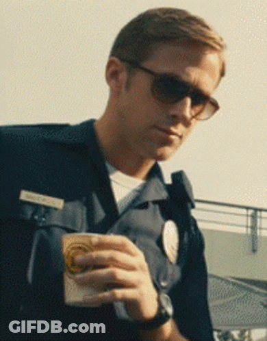 A Man In A Police Uniform Is Holding A Cup GIF