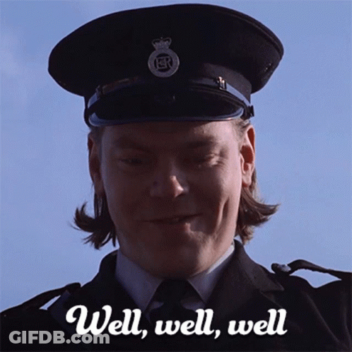 A Man In A Police Uniform Is Smiling With The Words Well Well Well Behind Him GIF