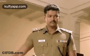 A Man In A Police Uniform Is Standing In A Room And Talking To Someone . GIF