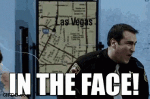 A Man In A Police Uniform Is Standing In Front Of A Map Of Las Vegas . GIF