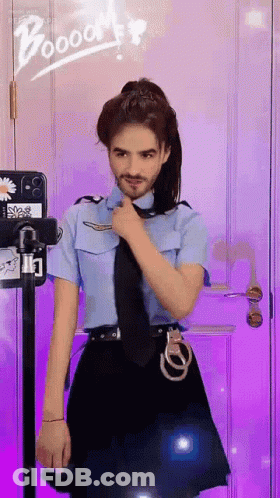 A Man In A Police Uniform Is Standing In Front Of A Purple Door GIF