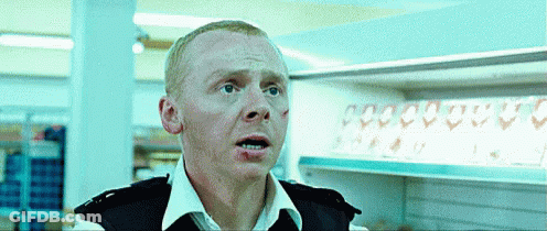 A Man In A Police Uniform Is Standing In Front Of A Row Of Empty Shelves GIF