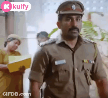 A Man In A Police Uniform Is Standing In Front Of A Woman Holding A Yellow Folder . GIF