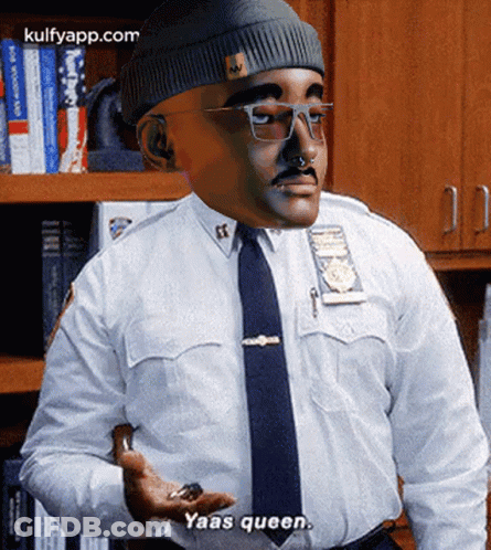 A Man In A Police Uniform Says Yaas Queen While Holding Something In His Hand GIF