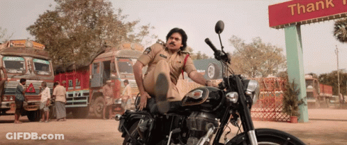 Police Officer On Motorcycle In Front Of Thank You Sign GIF