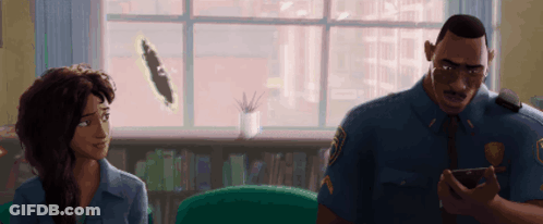 A Man In A Police Uniform Talks To A Woman In A Living Room GIF