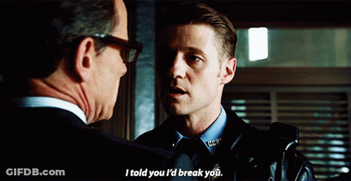 A Man In A Police Uniform Talks To Another Man In A Suit GIF
