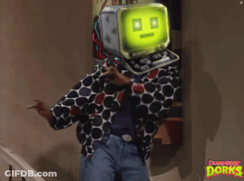 A Man In A Polka Dot Shirt Has A Computer Head On His Head And The Word Dorks Is On The Wall GIF