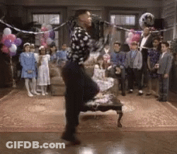 A Man In A Polka Dot Shirt Is Dancing In Front Of A Crowd GIF