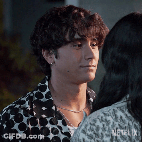 A Man In A Polka Dot Shirt Is Looking At A Woman In A Netflix Ad . GIF