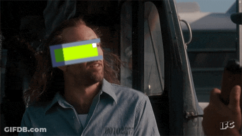 A Man In A Prison Uniform Has A Green Block On His Eye GIF