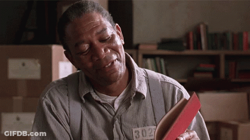 A Man In A Prison Uniform Has A Tag That Says 1302 GIF