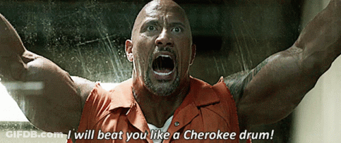 A Man In A Prison Uniform Says I Will Beat You Like A Cherokee Drum GIF