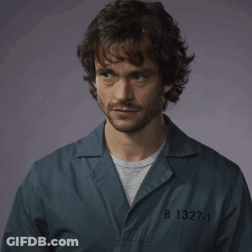 A Man In A Prison Uniform With The Number B 1327-1 GIF