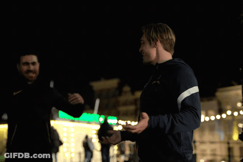 A Man In A Puma Jacket Shakes Hands With Another Man In A Black Jacket GIF