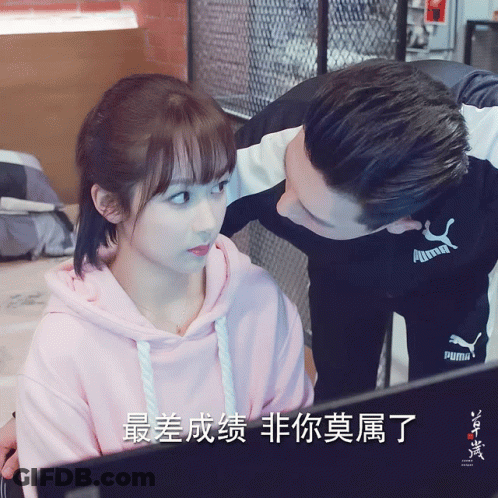 A Man In A Puma Shirt Kisses A Woman GIF