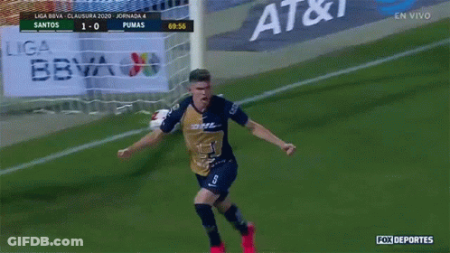 A Man In A Pumas Jersey Celebrates A Goal On A Soccer Field GIF