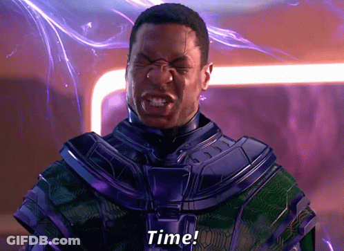 A Man In A Purple And Green Suit Is Screaming The Word Time GIF