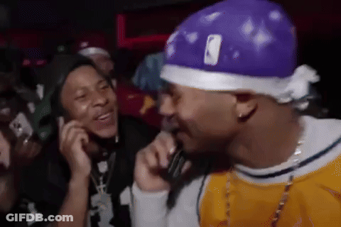 Man In Purple Hat Talking Into Microphone GIF