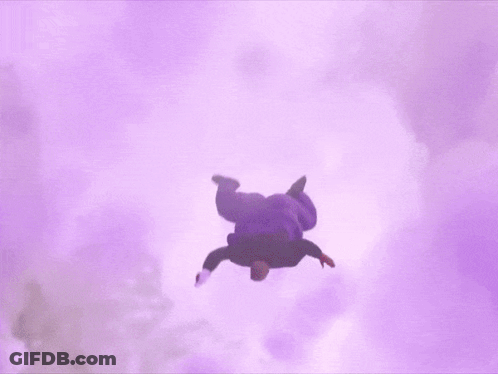 A Man In A Purple Hoodie Is Doing A Handstand In The Air In A Cloudy Sky . GIF
