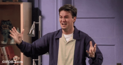 A Man In A Purple Jacket Is Making A Funny Face With His Arms Outstretched GIF