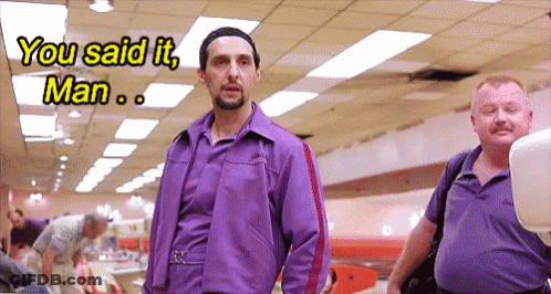 A Man In A Purple Jacket Is Talking To Another Man GIF