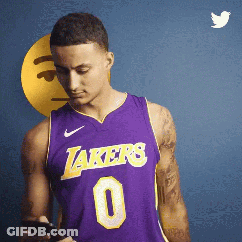 A Man In A Purple Lakers Jersey Looks At His Cell Phone GIF