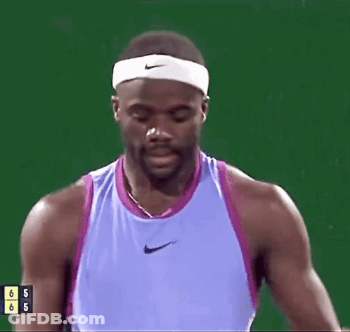 A Man In A Purple Nike Tank Top Is Drinking From A Bottle GIF