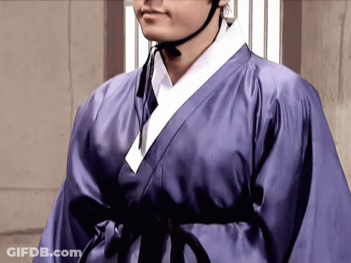 A Man In A Purple Robe With A Black Belt GIF