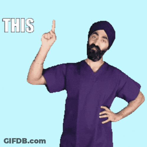 A Man In A Purple Scrub Top Is Pointing Up With The Word This Behind Him GIF