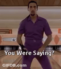 A Man In A Purple Shirt And Pants Is Standing On A Bowling Alley And Says `` You Were Saying '' . GIF