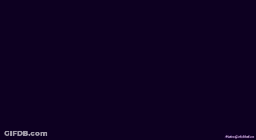 A Man In A Purple Shirt And Tie Has A Tattoo On His Wrist . GIF