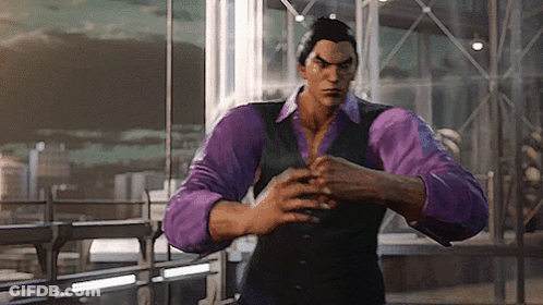 A Man In A Purple Shirt And Vest Is Standing In Front Of A Window . GIF