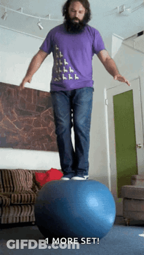 A Man In A Purple Shirt Is Balancing On A Blue Ball With The Words " 1 More Set " Below Him GIF