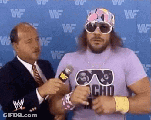 A Man In A Purple Shirt Is Being Interviewed By A Man In A Suit And Tie . GIF