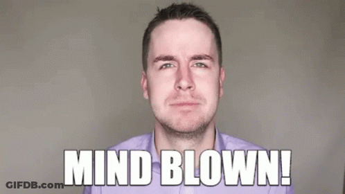 A Man In A Purple Shirt Is Blowing His Fist In The Air . GIF