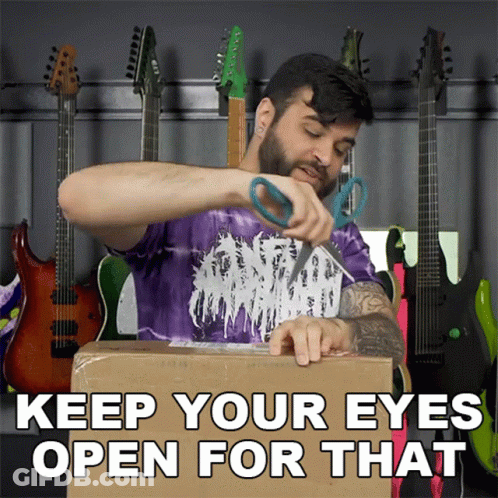 A Man In A Purple Shirt Is Cutting A Cardboard Box With The Words " Keep Your Eyes Open For That " GIF