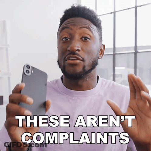 A Man In A Purple Shirt Is Holding A Cell Phone And Says These Aren 'T Complaints GIF