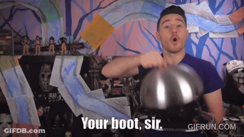 A Man In A Purple Shirt Is Holding A Metal Object And Says " Your Boot Sir " GIF