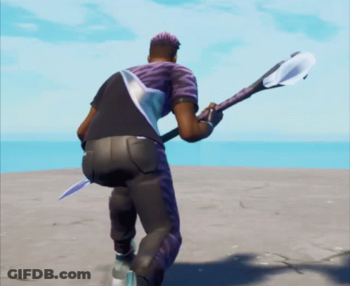 A Man In A Purple Shirt Is Holding A Sword GIF