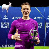 A Man In A Purple Shirt Is Holding A Trophy And Giving A Thumbs Up Sign GIF