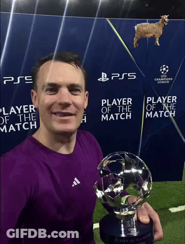 A Man In A Purple Shirt Is Holding A Trophy In Front Of A Sign That Says Ps5 Player Of The Match GIF