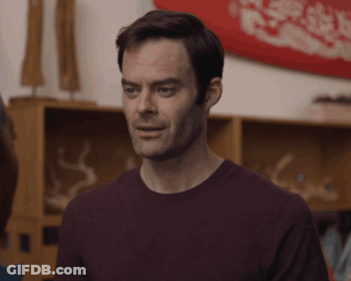 Man In Purple Shirt Looking At Camera GIF