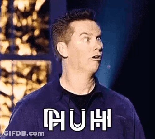 A Man In A Purple Shirt Is Making A Funny Face With The Word Huh Written On His Chest . GIF