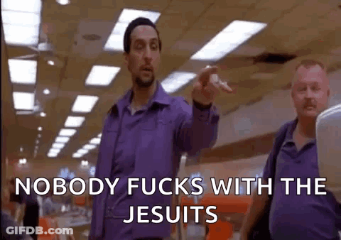 A Man In A Purple Shirt Is Pointing At Another Man In A Purple Shirt . GIF